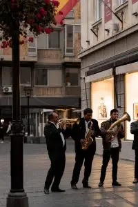 A lively band playing brass instruments on a bustling street in Belgrade, Serbia.